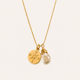 Naut & Chain compass charm necklace featuring a silver-toned pendant with intricate detailing on a delicate chain.