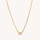 Gold solitaire baguette necklace by Naut & Chain featuring a sleek rectangular gemstone pendant on a delicate chain.