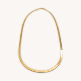 14K gold herringbone chain from Naut & Chain, close-up of sleek, polished gold jewelry with fine woven pattern.