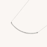 Silver diamond bar necklace named The Angela by Naut & Chain, displayed with shadows highlighting its sleek, modern design.