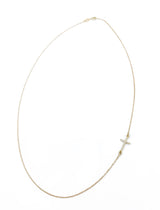 Gold necklace featuring a sideways pave diamond cross pendant by Naut & Chain, showcasing elegant jewelry design.