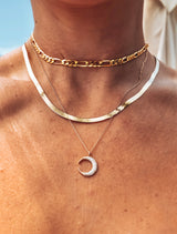 14K gold herringbone chain by Naut & Chain, close-up of the sleek, flat, woven gold jewelry chain on a neutral background.