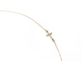 Gold necklace featuring a sideways pave diamond cross pendant, crafted by Naut & Chain.